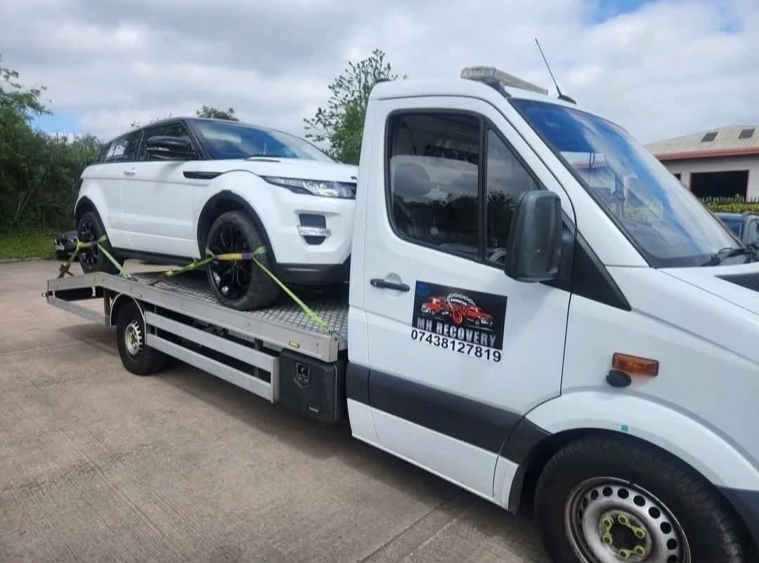 Black Mercedes-Benz flatbed recovery truck ready for deployment in Sheffield