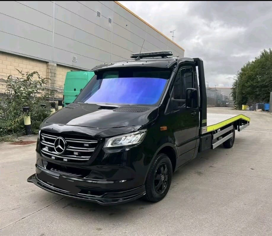 Black Mercedes-Benz flatbed recovery truck ready for deployment
